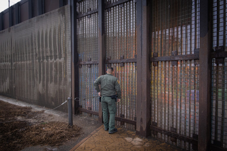USA, San Diego, 2019-11-20. Border Patrol agent patrols along a section of the U.S.-Mexico border fence. Photograph by F