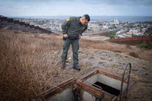 USA, San Diego, 2019-11-20. Border Patrol agent patrols along a section of the U.S.-Mexico border fence. Photograph by F