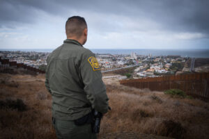 USA, San Diego, 2019-11-20. Border Patrol agent patrols along a section of the U.S.-Mexico border fence. Photograph by F