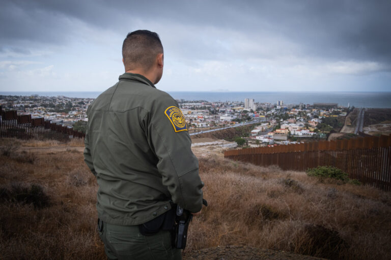 USA, San Diego, 2019-11-20. Border Patrol agent patrols along a section of the U.S.-Mexico border fence. Photograph by F