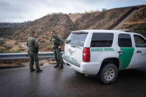 USA, San Diego, 2019-11-20. Border Patrol agent patrols along a section of the U.S.-Mexico border fence. Photograph by F