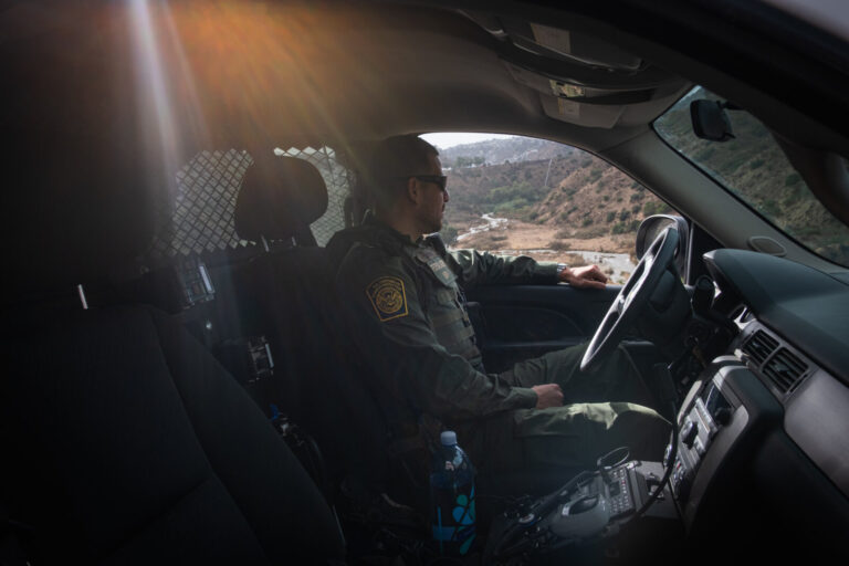 USA, San Diego, 2019-11-20. Border Patrol agent patrols along a section of the U.S.-Mexico border fence. Photograph by F