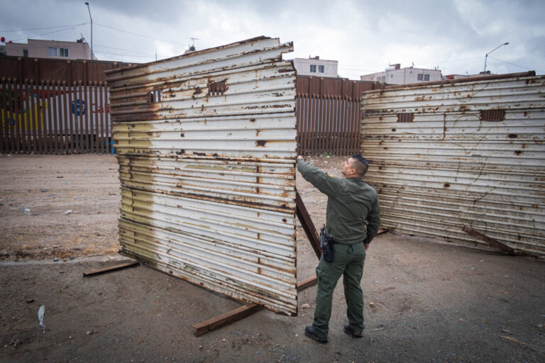 USA, San Diego, 2019-11-20. Border Patrol agent patrols along a section of the U.S.-Mexico border fence. Photograph by F