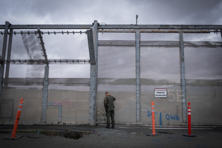 USA, San Diego, 2019-11-20. Border Patrol agent patrols along a section of the U.S.-Mexico border fence. Photograph by F