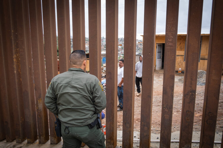 USA, San Diego, 2019-11-20. Border Patrol agent patrols along a section of the U.S.-Mexico border fence. Photograph by F