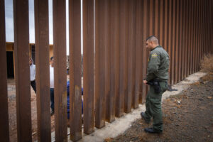 USA, San Diego, 2019-11-20. Border Patrol agent patrols along a section of the U.S.-Mexico border fence. Photograph by F