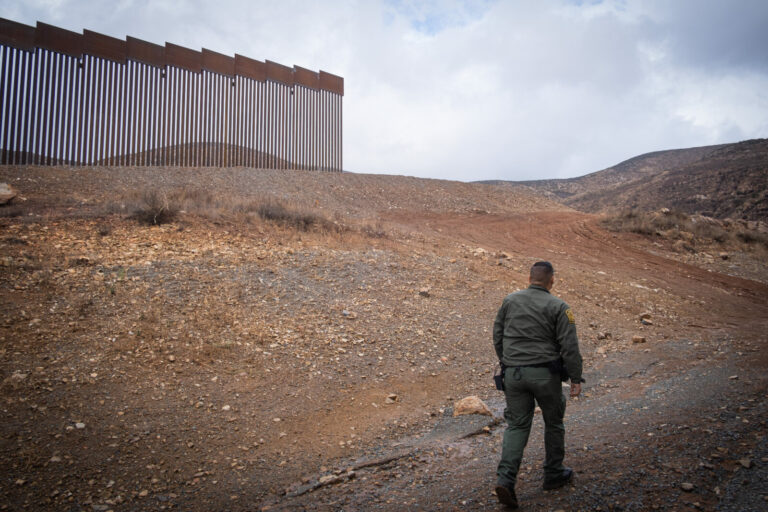 USA, San Diego, 2019-11-20. Border Patrol agent patrols along a section of the U.S.-Mexico border fence. Photograph by F