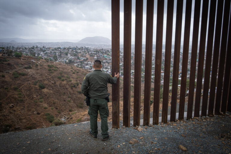 USA, San Diego, 2019-11-20. Border Patrol agent patrols along a section of the U.S.-Mexico border fence. Photograph by F