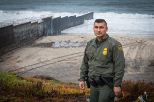 USA, San Diego, 2019-11-20. Border Patrol agent patrols along a section of the U.S.-Mexico border fence. Photograph by F