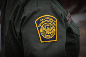 USA, San Diego, 2019-11-20. Border Patrol agent patrols along a section of the U.S.-Mexico border fence. Photograph by F