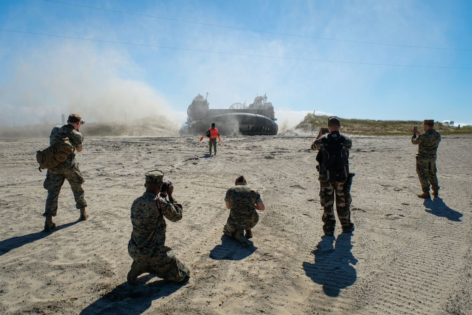 USA, Jacksonville, 2017-10-25. Combat camera team soldiers in front of an hovercraft during the Amphibious Bold Alligato