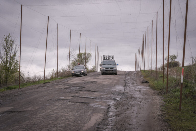 Ukraine, Pavlograd, 2026-04-24. Kilometres of netting strung on poles turn the supply roads of the Ukrainian rear into c