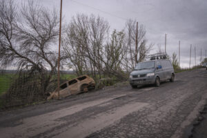 Ukraine, Pavlograd, 2026-04-24. Kilometres of netting strung on poles turn the supply roads of the Ukrainian rear into c