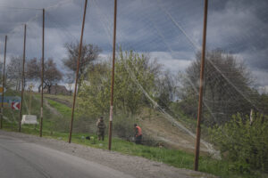 Ukraine, Pavlograd, 2026-04-24. Kilometres of netting strung on poles turn the supply roads of the Ukrainian rear into c