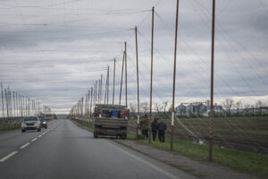 Ukraine, Pavlograd, 2026-04-24. Kilometres of netting strung on poles turn the supply roads of the Ukrainian rear into c