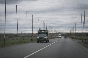 Ukraine, Pavlograd, 2026-04-24. Kilometres of netting strung on poles turn the supply roads of the Ukrainian rear into c
