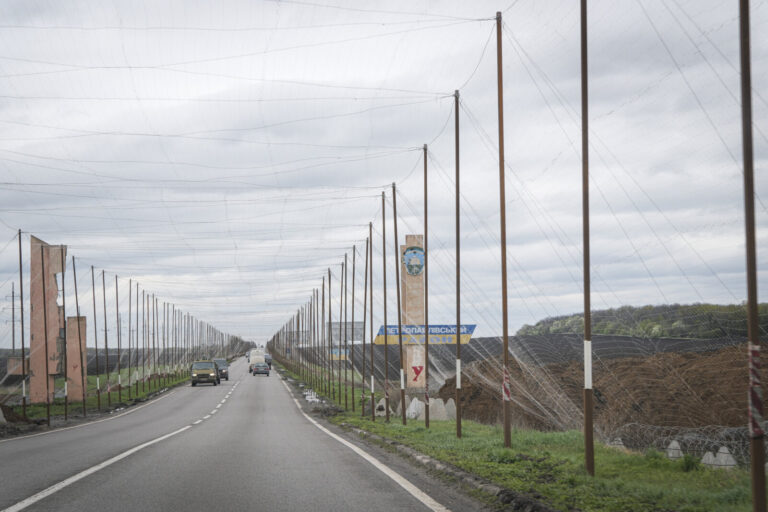 Ukraine, Pavlograd, 2026-04-24. Kilometres of netting strung on poles turn the supply roads of the Ukrainian rear into c