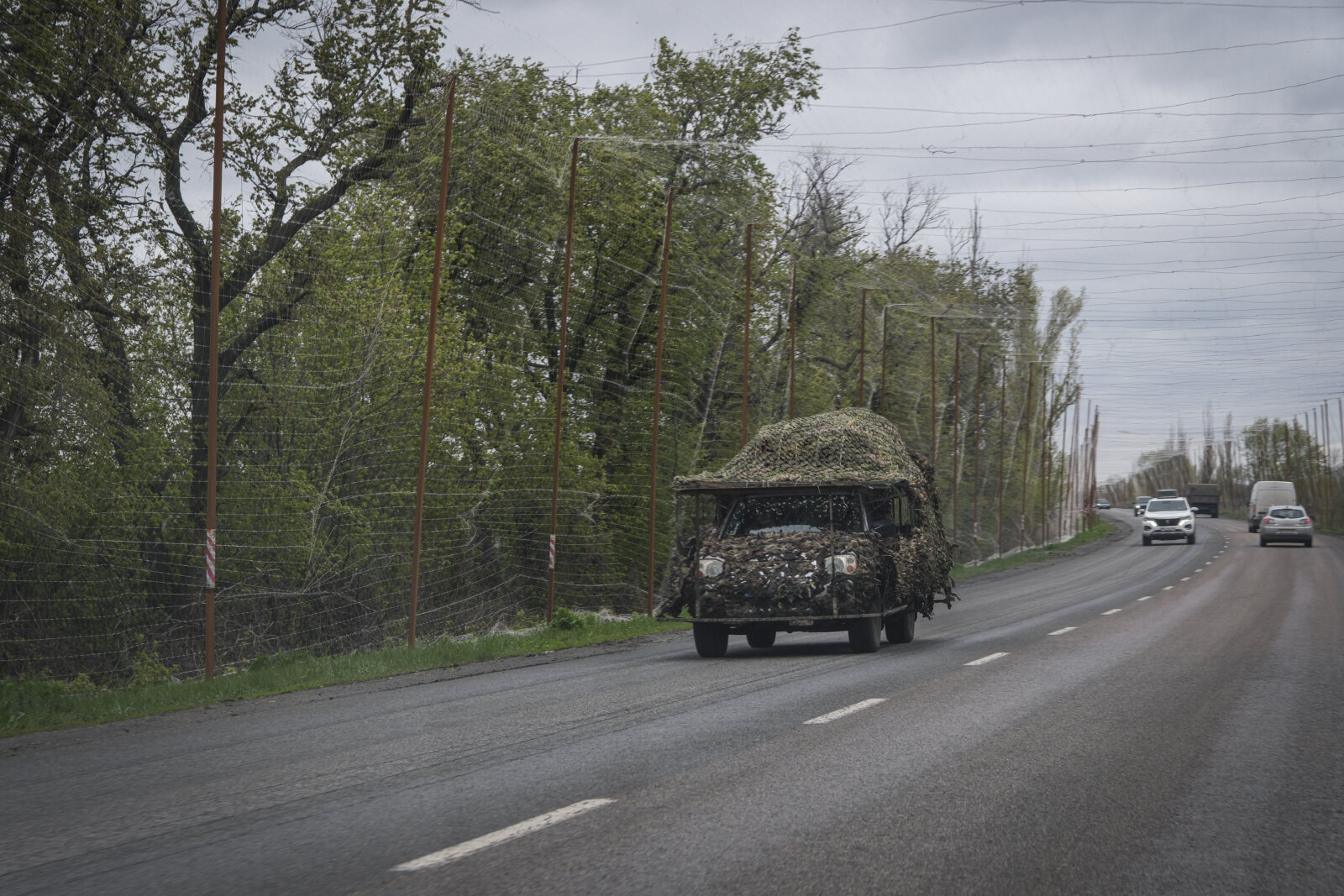 Ukraine, Pavlograd, 2026-04-24. Kilometres of netting strung on poles turn the supply roads of the Ukrainian rear into c