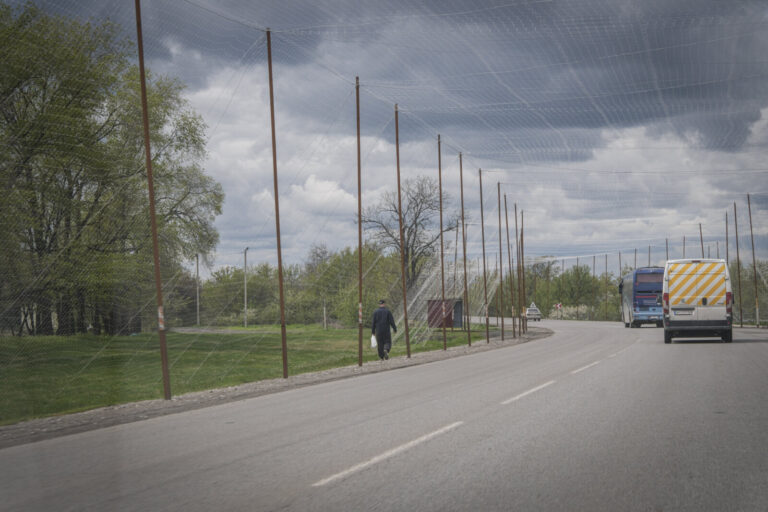 Ukraine, Pavlograd, 2026-04-24. Kilometres of netting strung on poles turn the supply roads of the Ukrainian rear into c